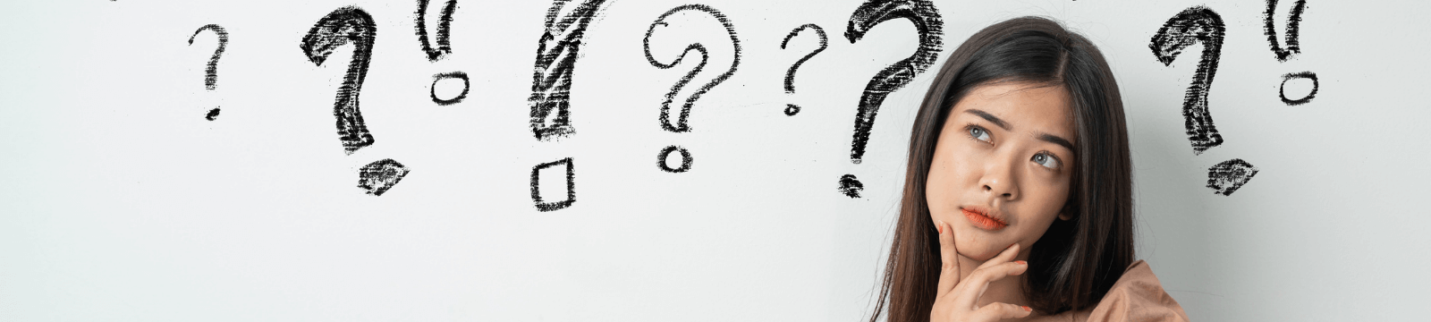 Lady with a puzzled look with question marks around her