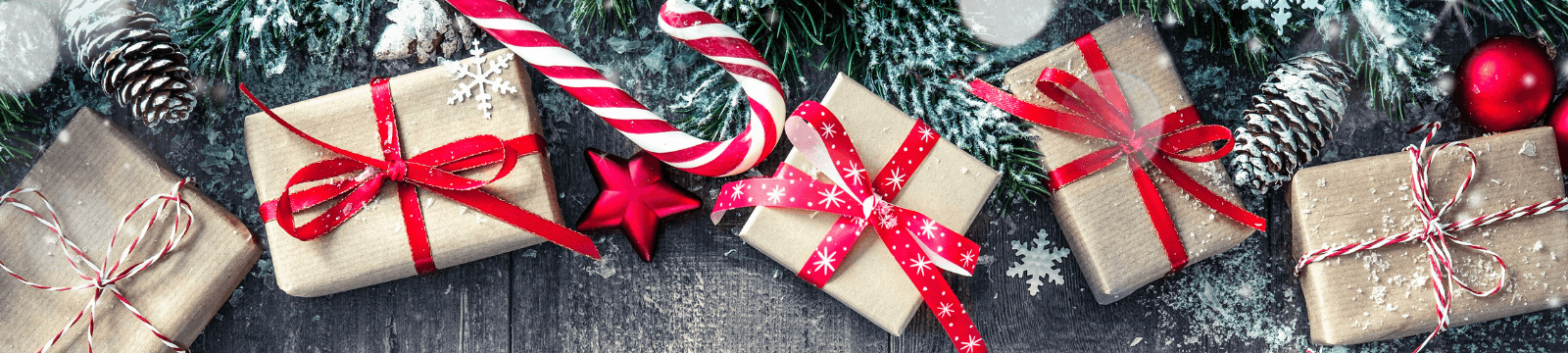 Christmas presents dusted in snow with pinecones and candy canes