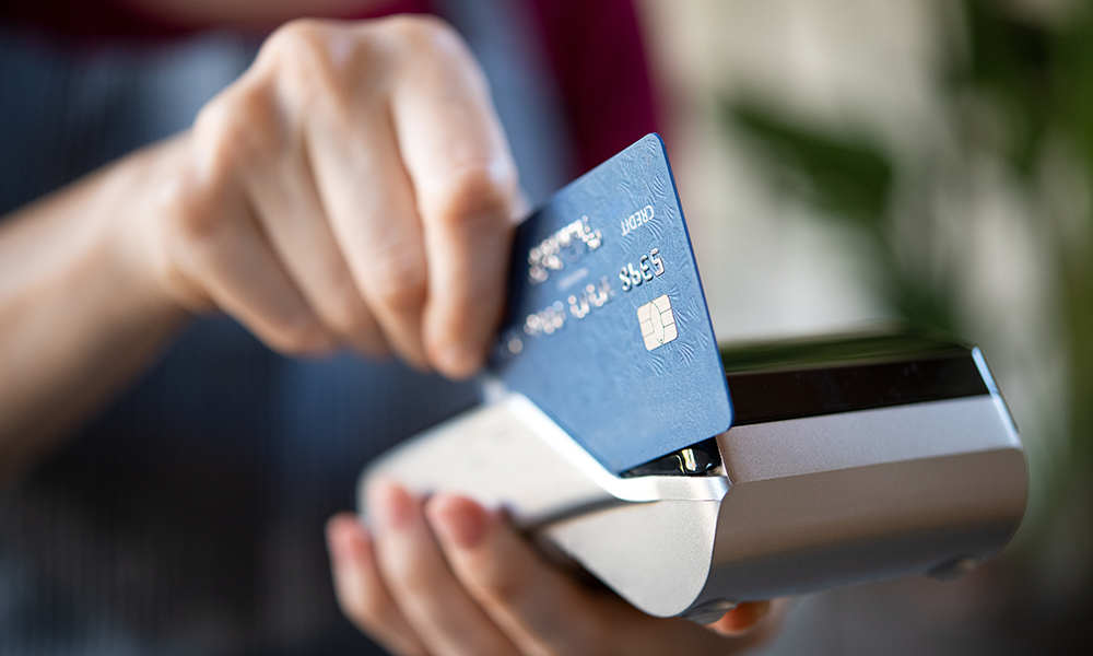 woman paying with a debit card
